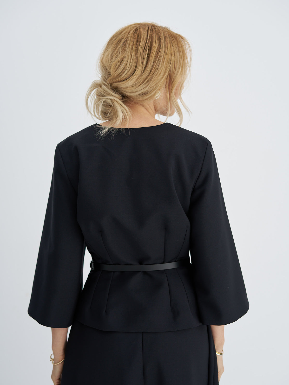 Back view of belted wool-mohair jacket showing shaping darts and three-quarter sleeves