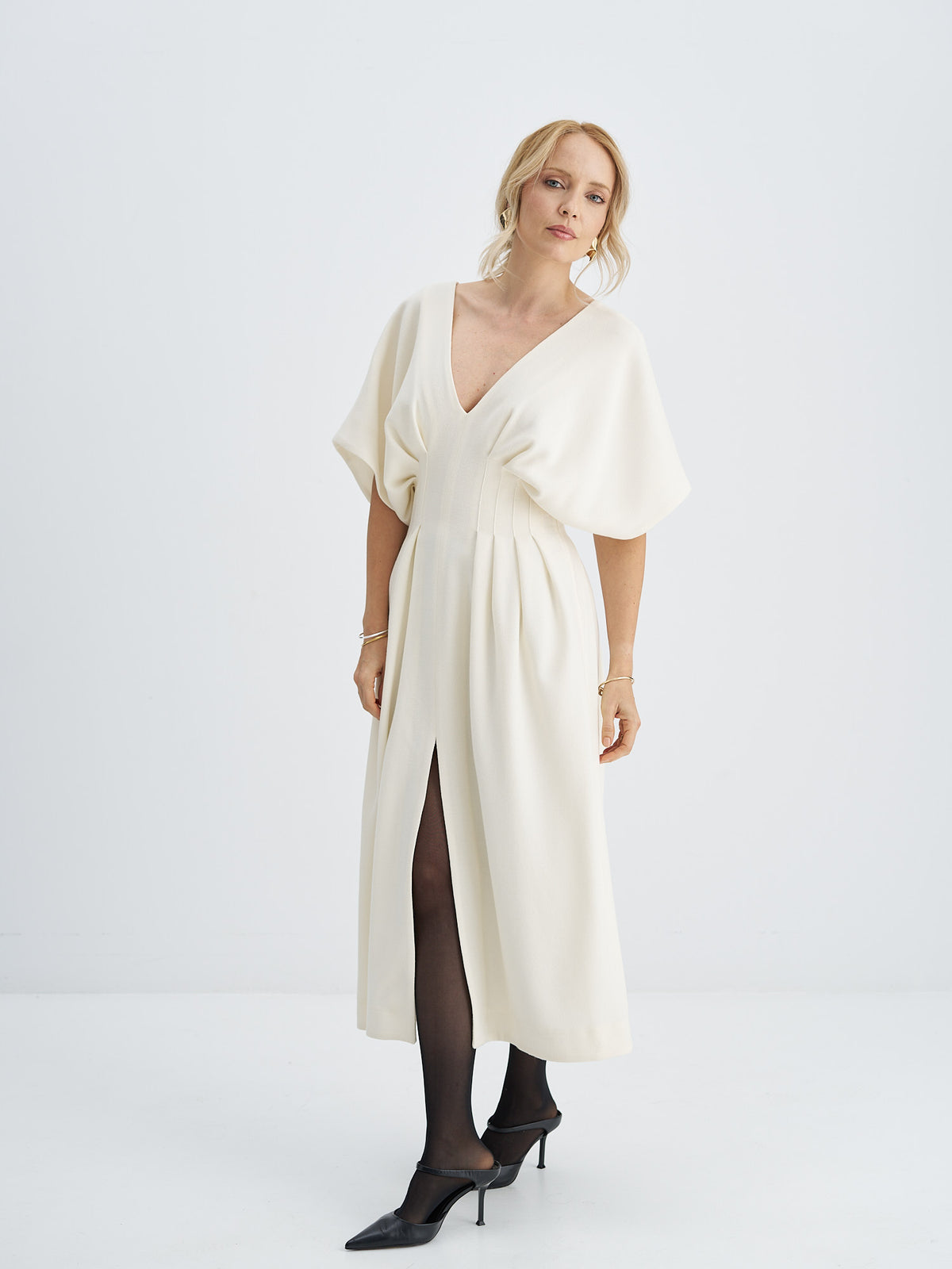 Ivory wool-crepe midi dress with a V-neckline, wide draped sleeves, a pleated waist and front slit