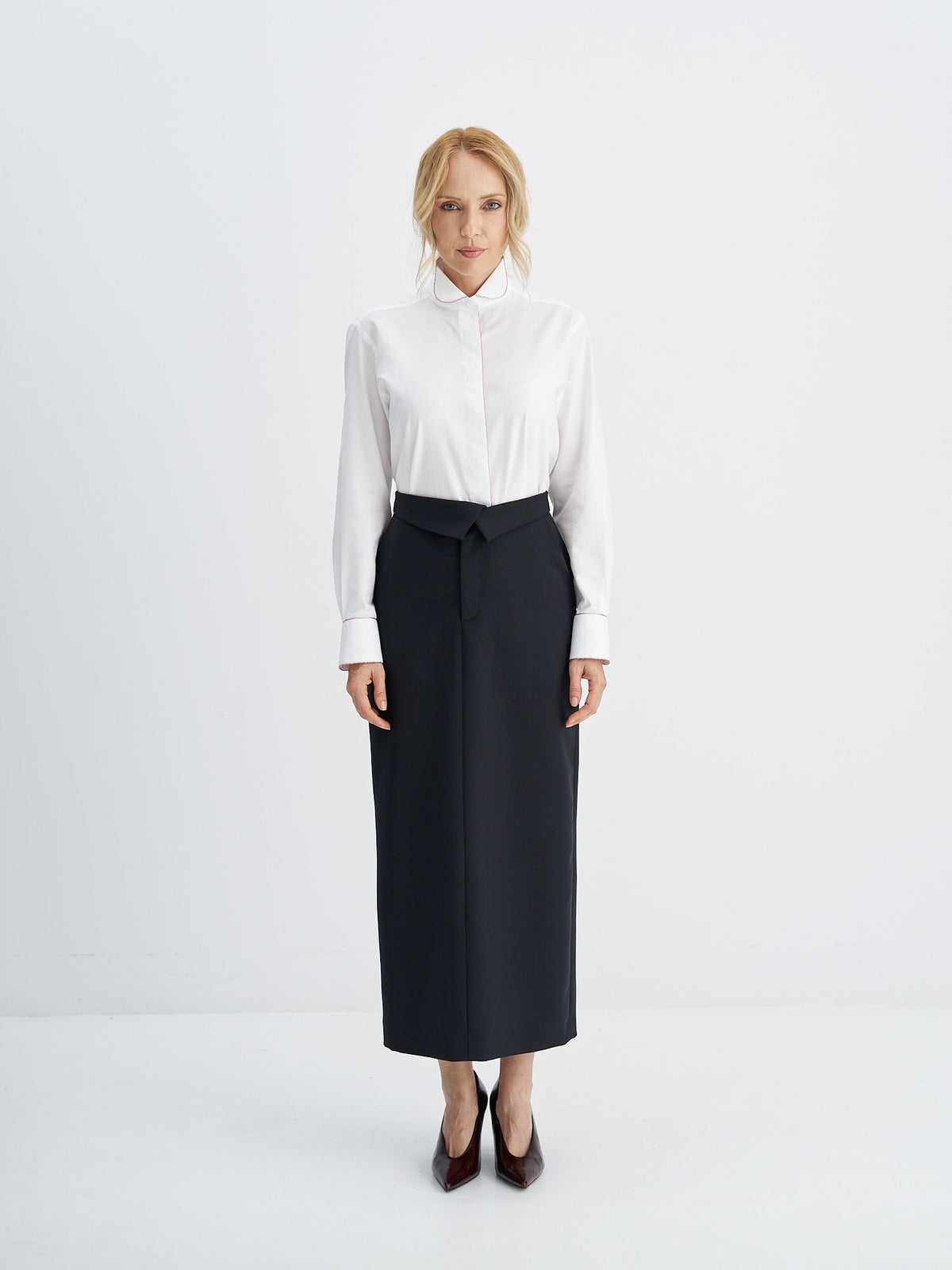 High-waisted wool-mohair midi skirt styled with a white shirt and burgundy pumps