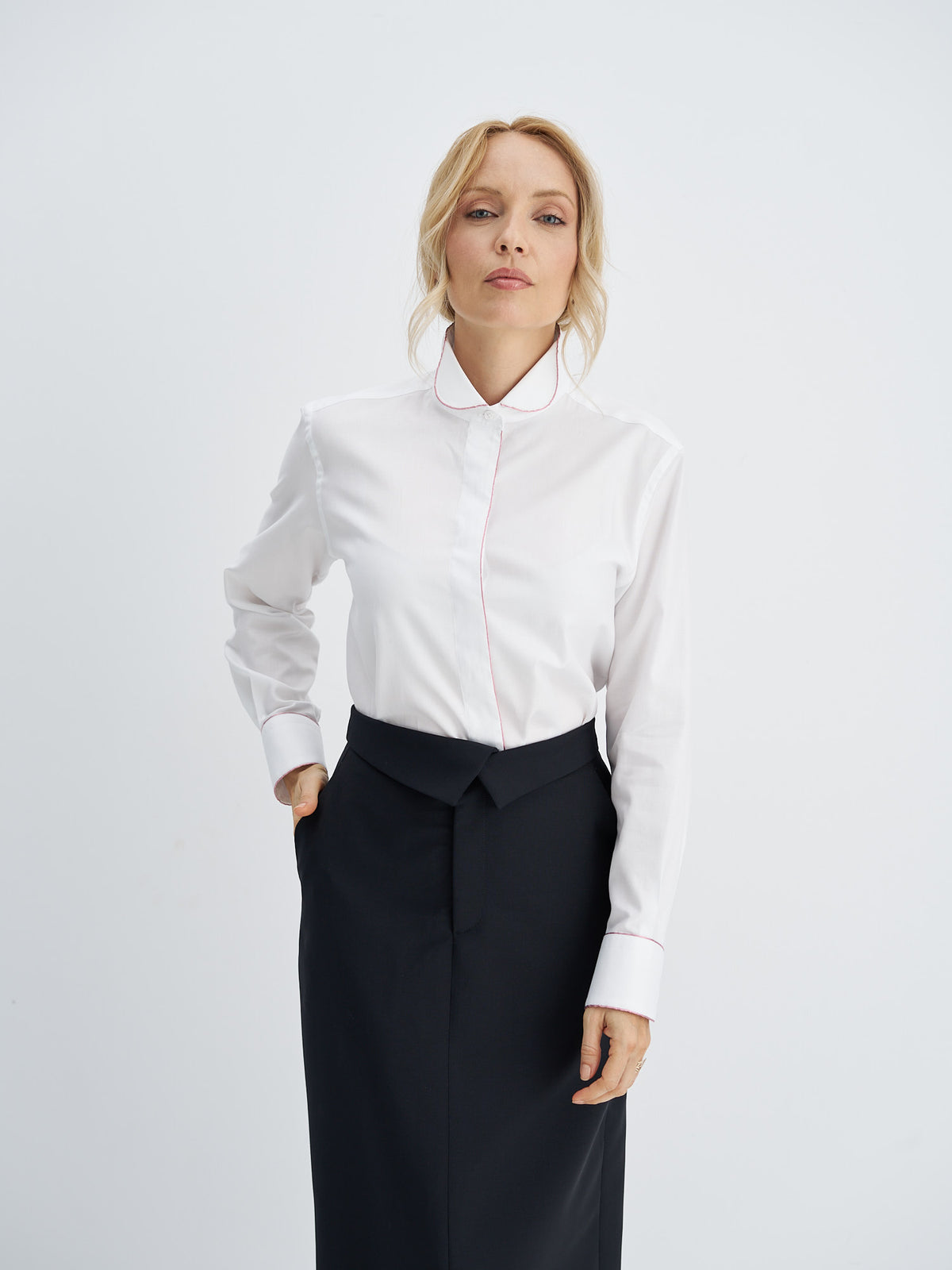 Three-quarter back view of the straight midi skirt showing the high waist and back slit