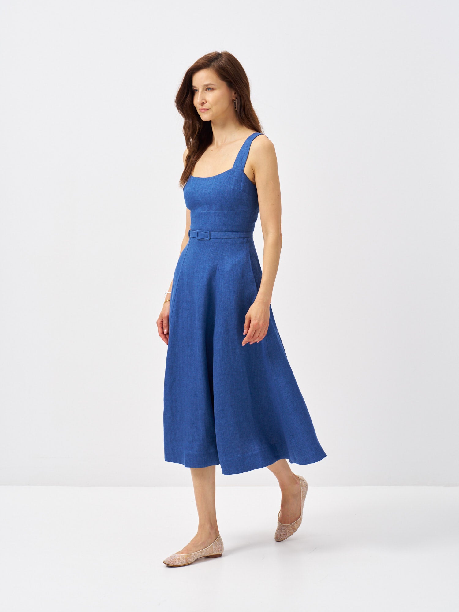 Blue linen midi dress with fitted bodice, wide shoulder straps, matching belt and side pockets