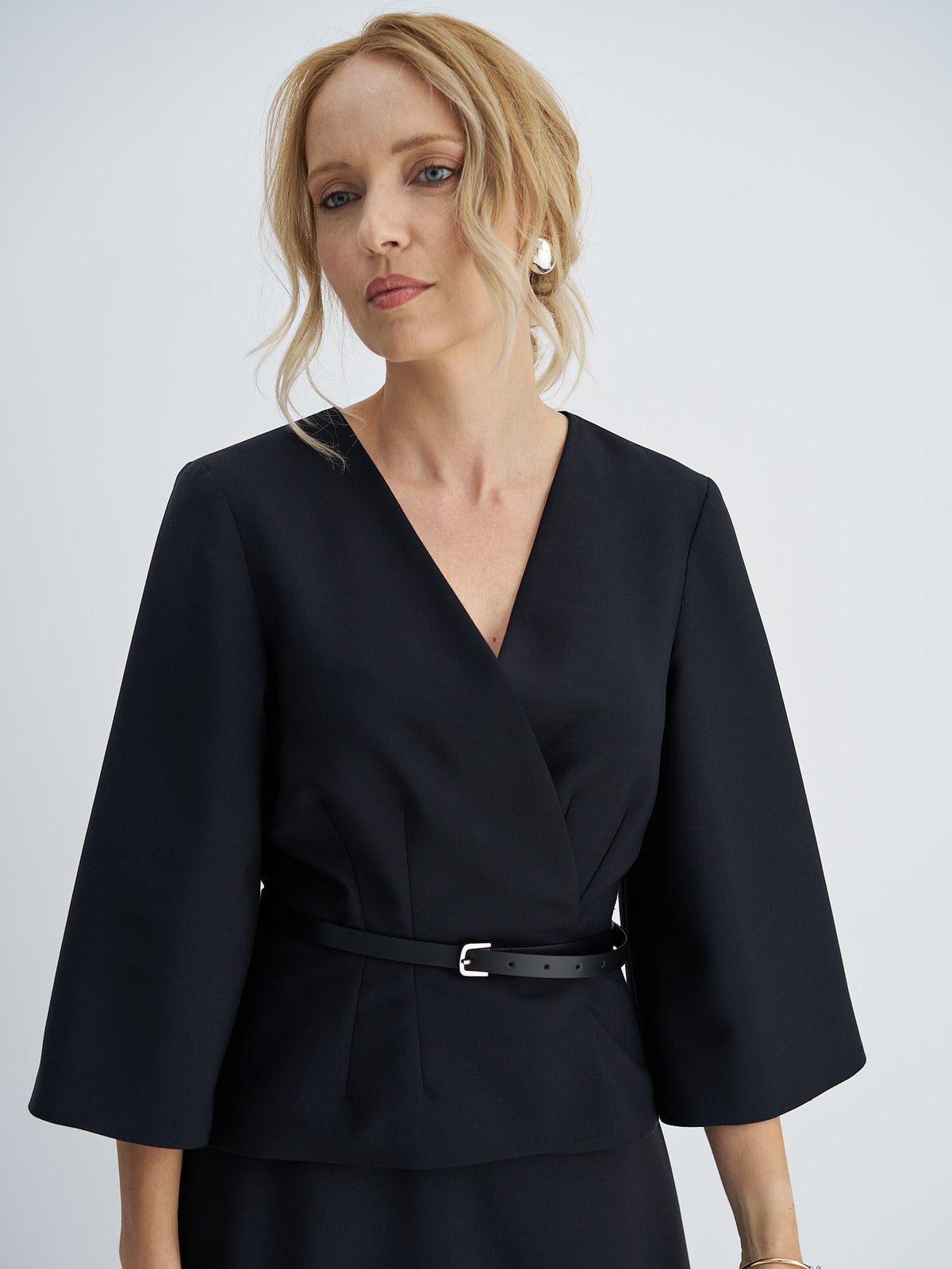 Front view of wool-mohair wrap jacket with a V-neckline, wide three-quarter sleeves and a narrow leather belt