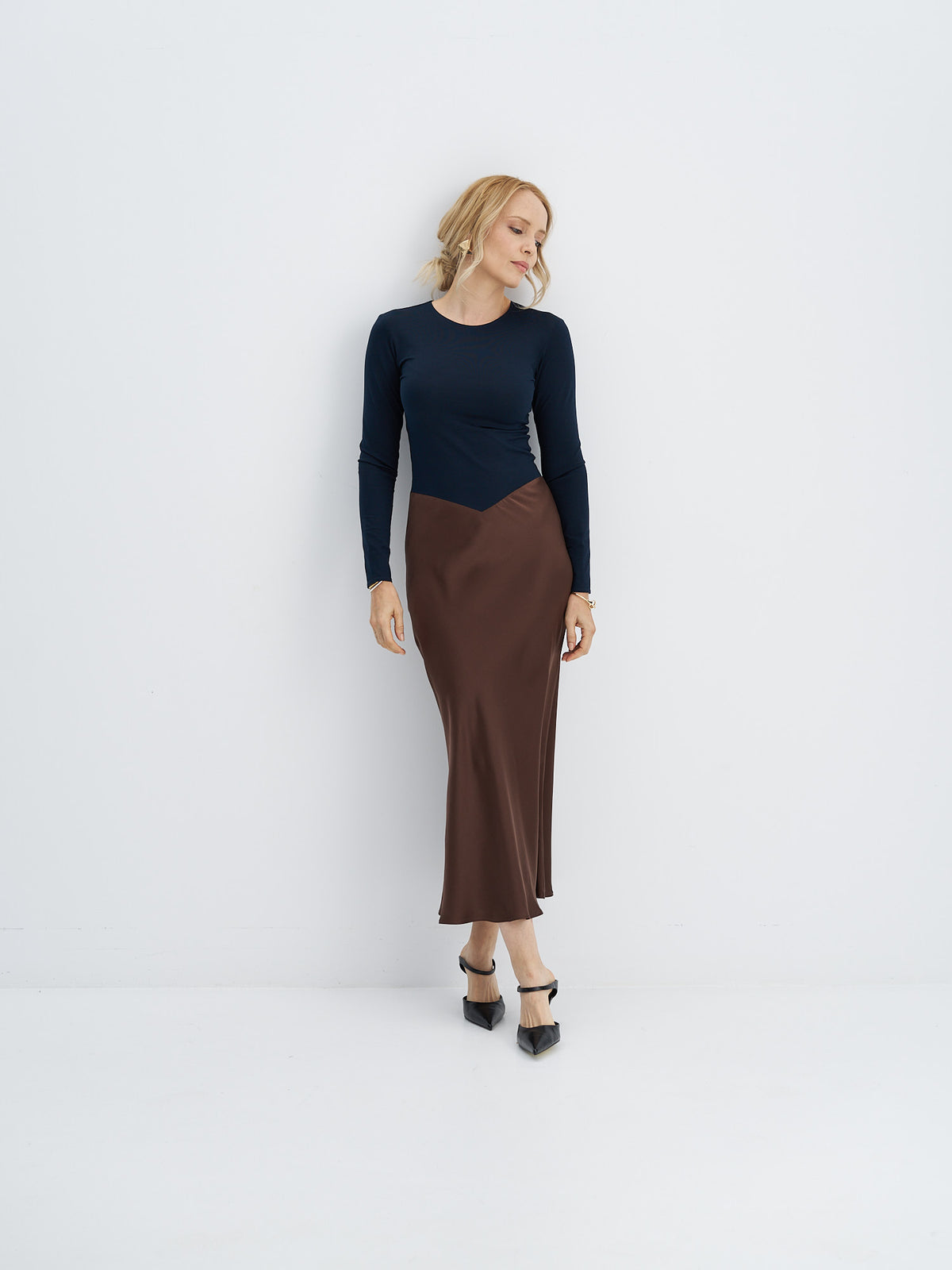 Front view of midi dress with a dark cotton-jersey bodice, pointed waist seam and chocolate brown silk skirt