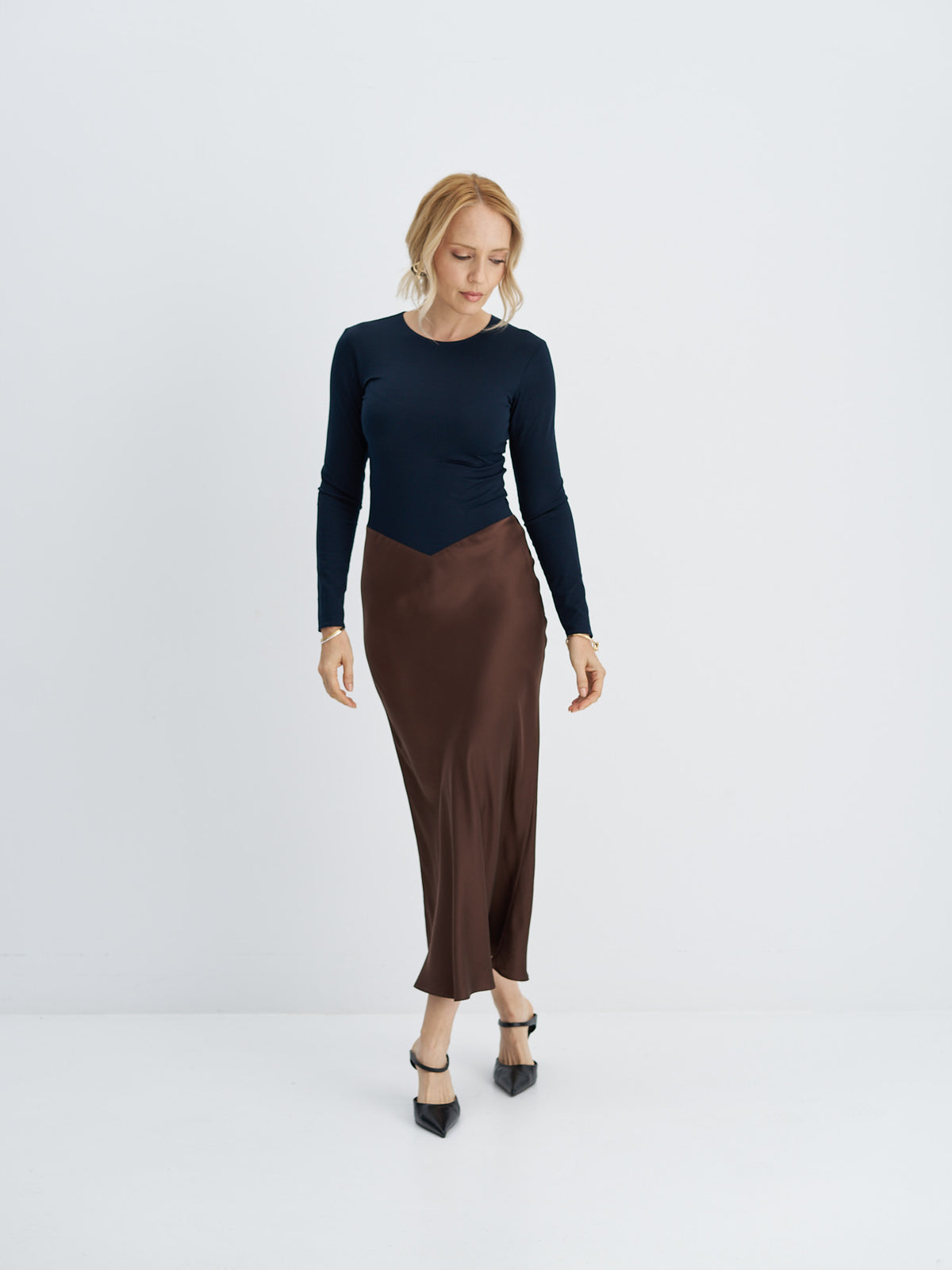 Cotton-jersey and silk midi dress in motion, showing the fluid bias-cut skirt and long sleeves