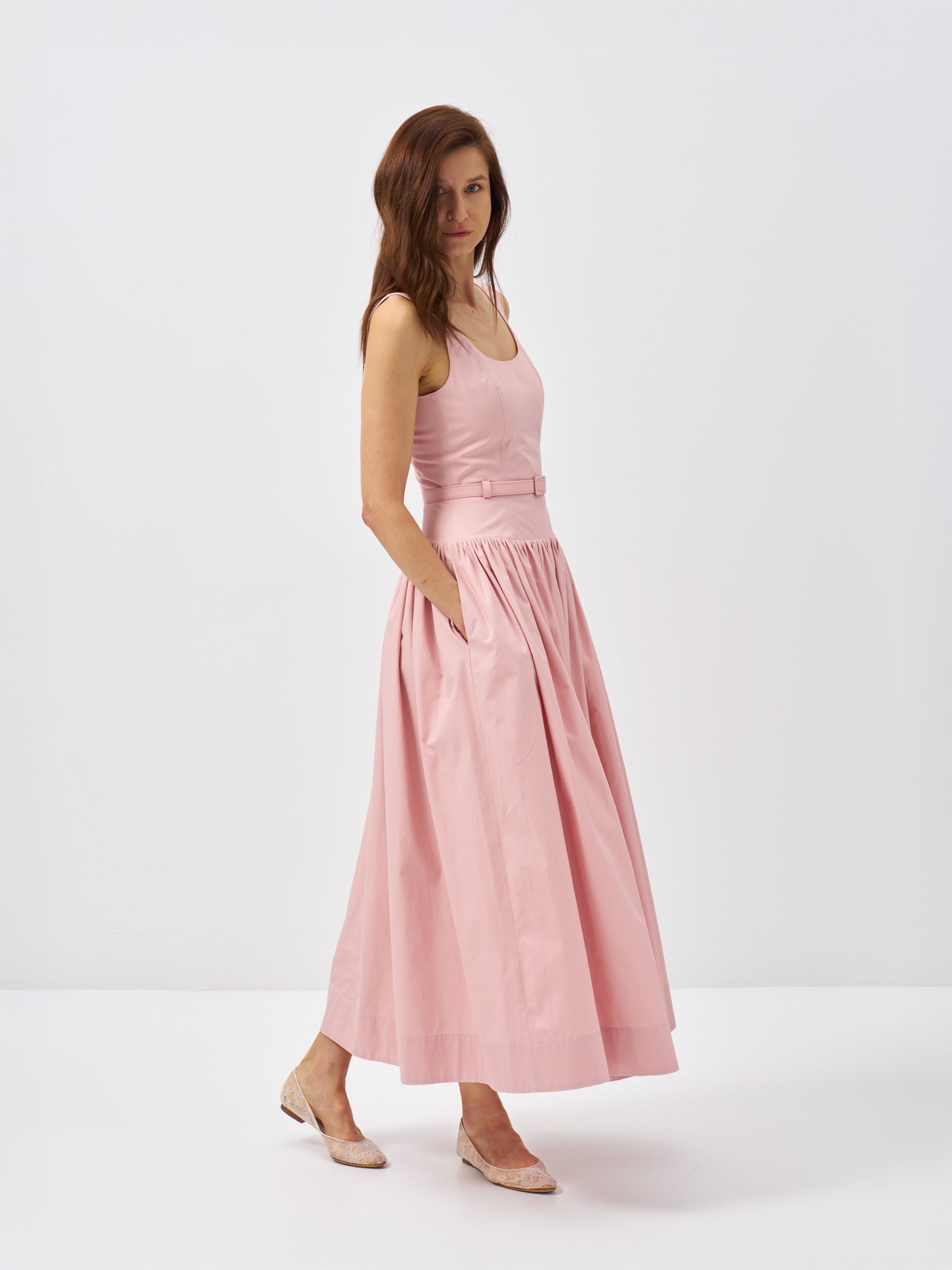 Front view of a pink cotton poplin maxi dress with a fitted bodice, defined waist and matching belt